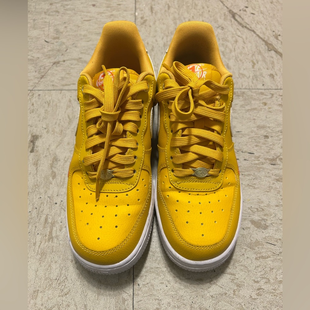 Yellow and white Nike shoes